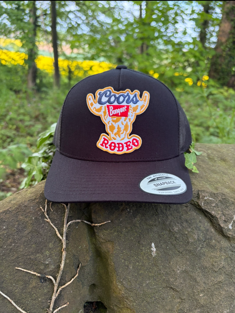 Coors Rodeo Patch on a Black 5 - Panel Trucker Hat